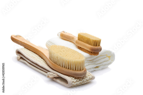 A set of items from natural materials for body care isolated on a white background. Dry massage brush, washcloth, pumice stone. Self-care concept