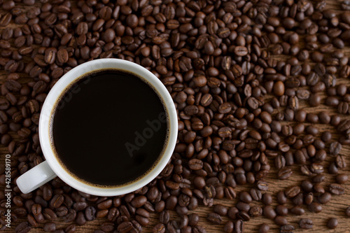 Coffee cup and coffee beans roasted on wooden background,Top view,copy space.