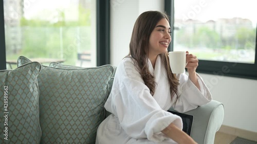 Portrait of a young beautiful woman having a tea