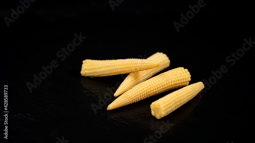 Miniature corn cobs, on black background
