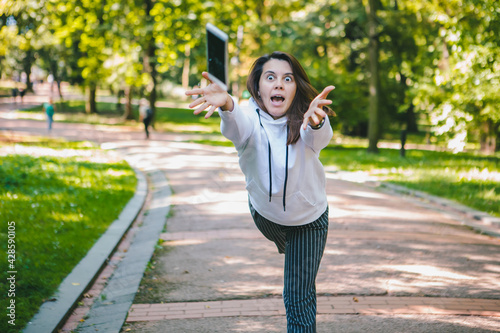 young woman let down mobile phone on stone ground photo