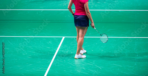 Badminton player beats the shuttlecock in the arena © Augustas Cetkauskas