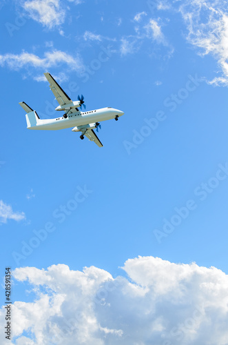 flight of the airplane (jet) over beautiful blue sky with white clouds