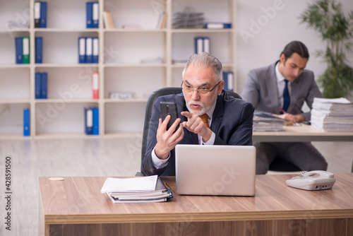 Two employees sitting at workplace