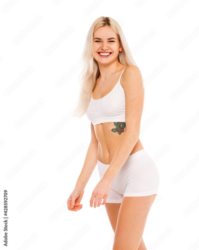 Young beautiful blonde woman in white sports underwear