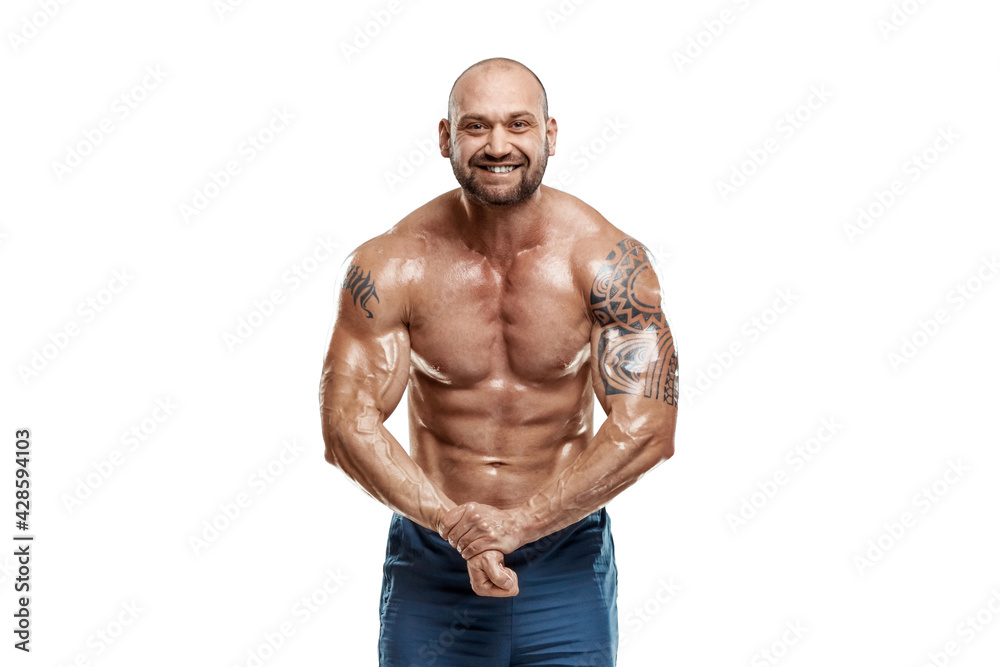 Tattooed male bodybuilder posing over white background. Fitness workout concept, muscle groups, watch your body.