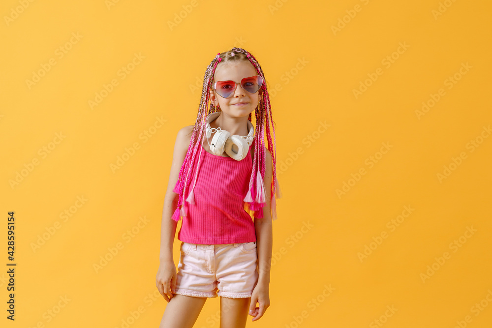 Crazy expressive trendy DJ girl in bright clothes, headphones an