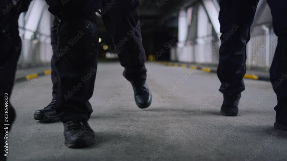 Closeup SWAT police officers legs walking in urban building