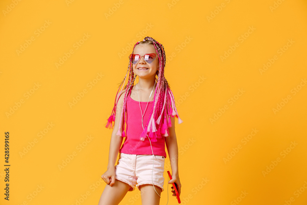 Beautiful European girl with dreadlocks. Mobile phone in the han Beautiful European girl with dreadlocks. Mobile phone in the han