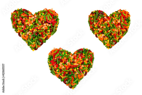 Heart made of vegetables. Corn, carrot, bell pepper, green beans. Isolated on white.