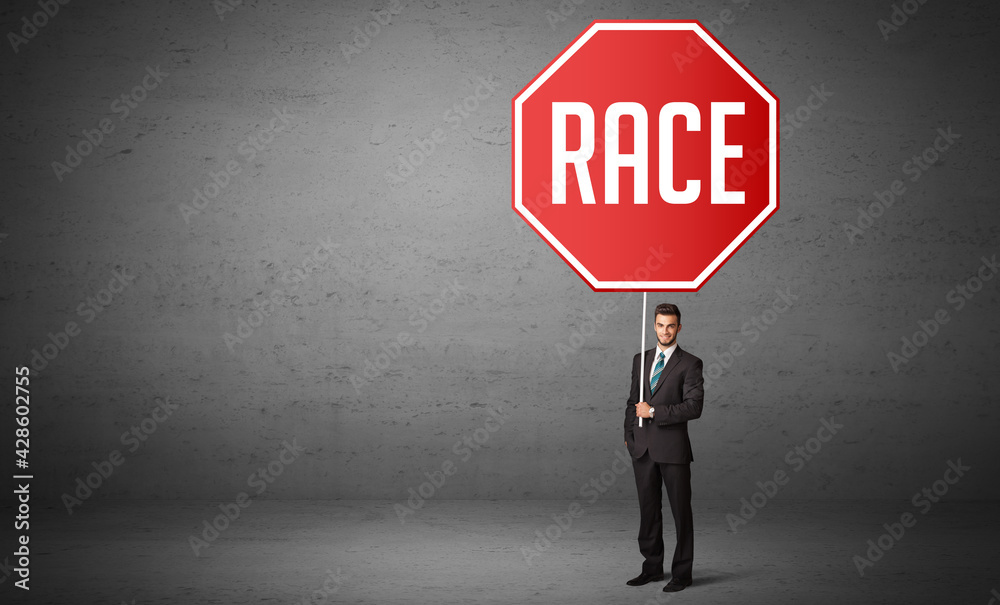 Young business person holding road sign Young business person holding road sign
