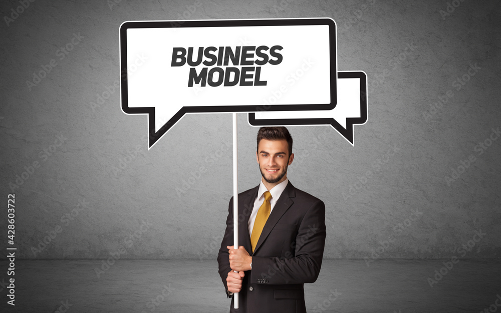 business person in casual holding road sign business person in casual holding road sign