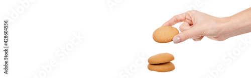 Hand with home made cookie isolated on white background.