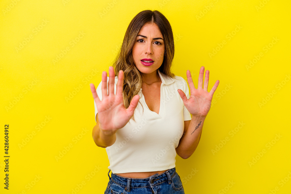 Young caucasian woman isolated on yellow background Young caucasian woman isolated on yellow background