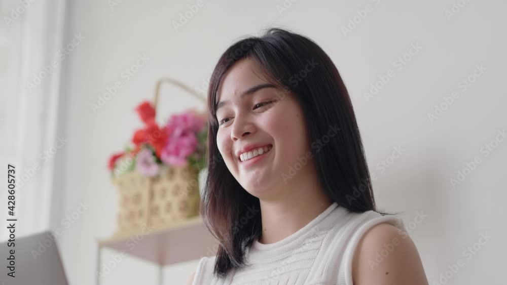 Asian businesswoman happy smiling and typing on laptop keyboard for work from home during quarantine coronavirus spread. Female in casual uniform online working in house for keep social distancing Asian businesswoman happy smiling and typing on laptop keyboard for work from home during quarantine coronavirus spread. Female in casual uniform online working in house for keep social distancing
