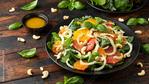 Fresh salad with fennel, orange, grapefruit, spinach and cashew nuts. healthy food.