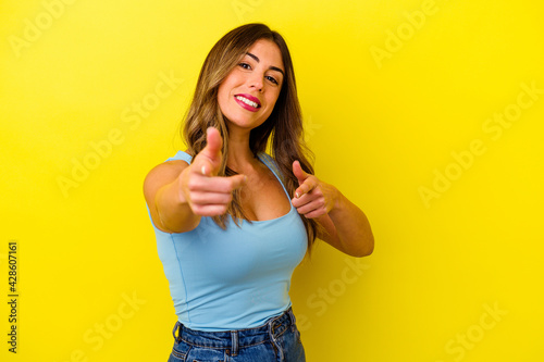 Young caucasian woman isolated on yellow background