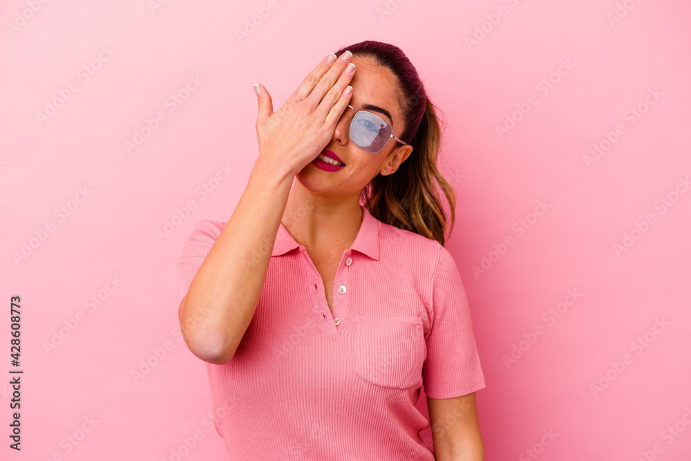 Fototapeta premium Young caucasian woman isolated on pink background