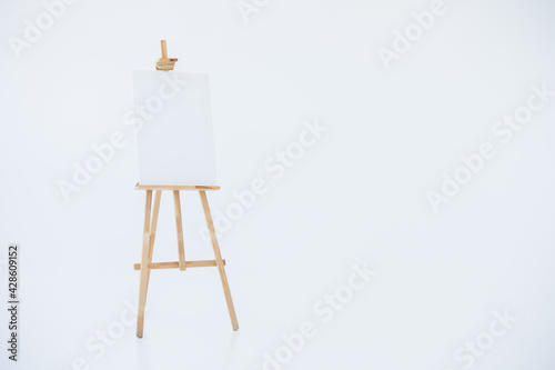 Fototapeta advertising stand or flip chart or blank artist easel isolated on white