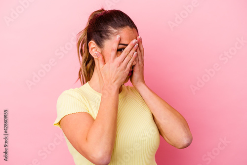 Young caucasian woman isolated on pink background