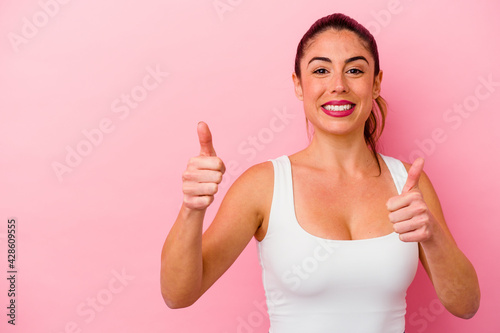 Young caucasian woman isolated on pink background