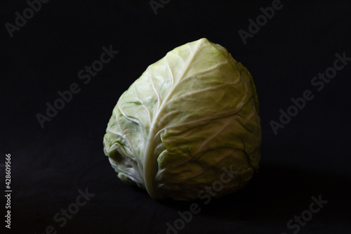 Fresh and healty green cabbage on a black background, closeup