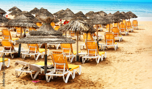 Umbrellas and sunbeds on the sandy beach of Agadir, Morocco