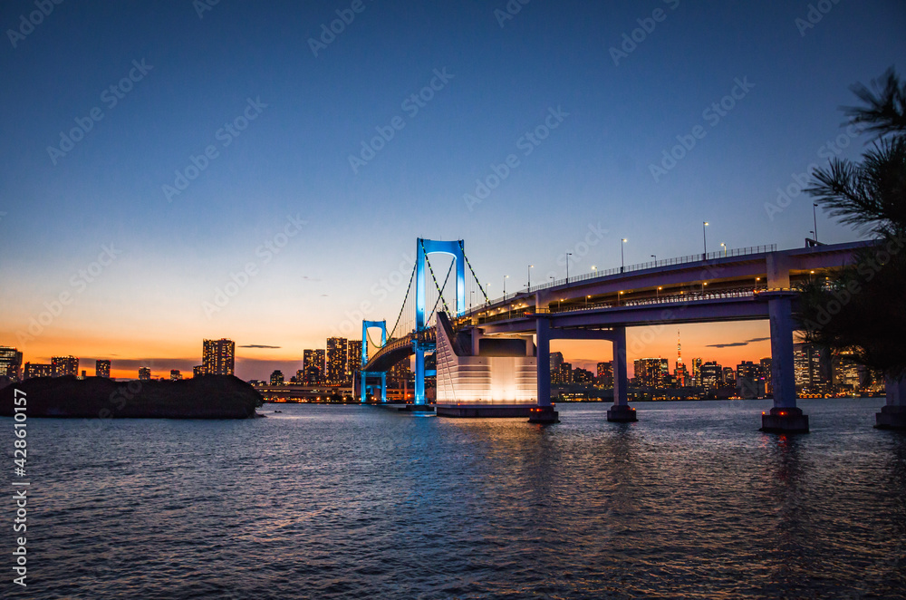 Cityscape view of Tokyo Bay , Rainbow bridge and Tokyo Tower at Sunset
