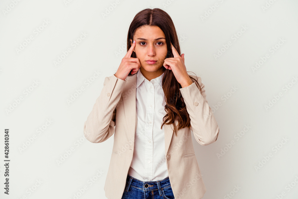 Young Indian business woman isolated on white background focused on a task, keeping forefingers pointing head. Young Indian business woman isolated on white background focused on a task, keeping forefingers pointing head.