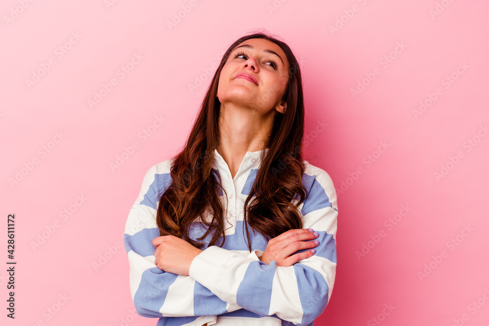 Young Indian woman isolated on pink background dreaming of achieving goals and purposes Young Indian woman isolated on pink background dreaming of achieving goals and purposes