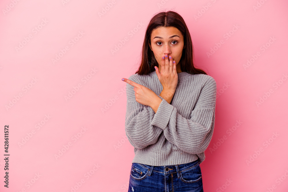 Young Indian woman isolated on pink background pointing to the side Young Indian woman isolated on pink background pointing to the side