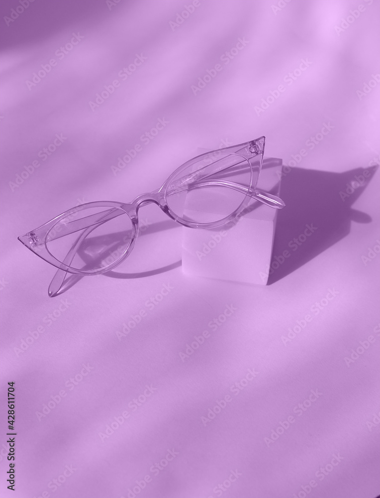 Sunglasses on square podium in trendy violet color background. Sunglasses on square podium in trendy violet color background.