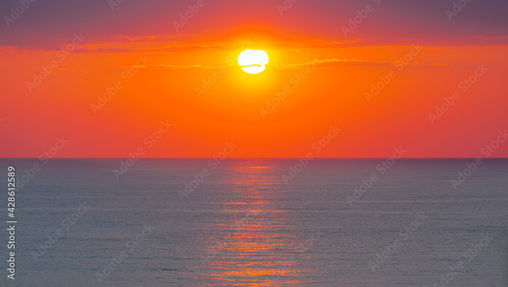 Amazing red sunset with yellow sun over the sea - Side, Turkey