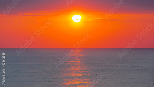 Amazing red sunset with yellow sun over the sea - Side, Turkey