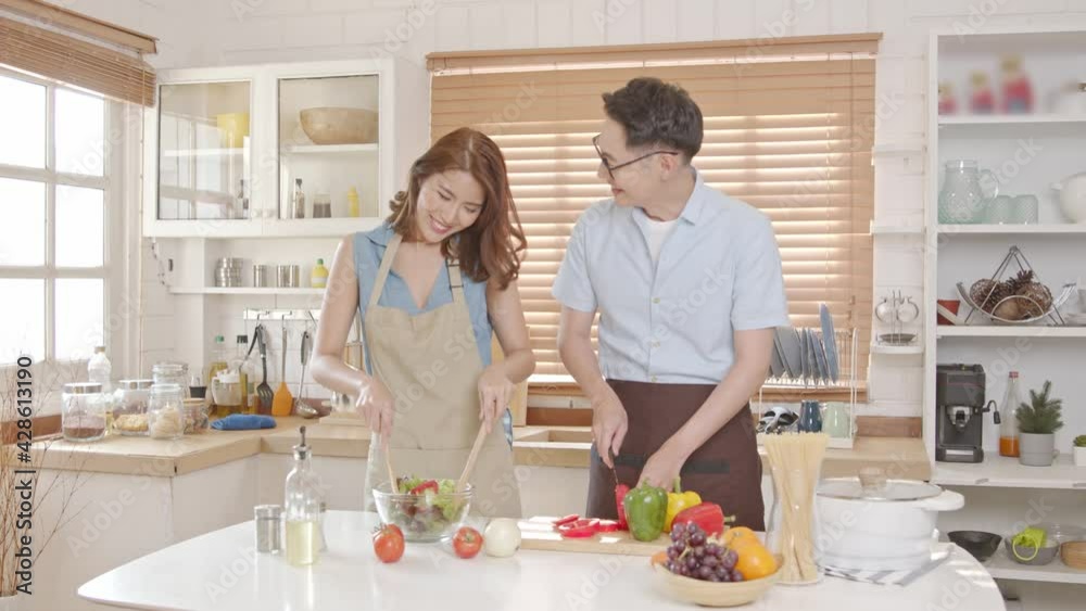 Asian family enjoy cooking salad together in kitchen room at home. Asian family enjoy cooking salad together in kitchen room at home.