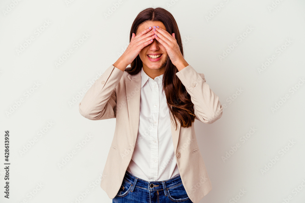 Young Indian business woman isolated on white background covers eyes with hands, smiles broadly waiting for a surprise. Young Indian business woman isolated on white background covers eyes with hands, smiles broadly waiting for a surprise.
