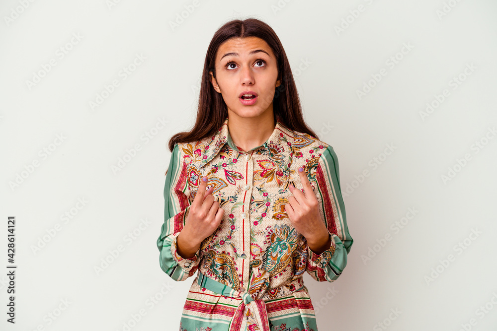 Young Indian woman isolated on white background pointing upside with opened mouth. Young Indian woman isolated on white background pointing upside with opened mouth.
