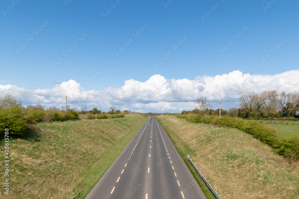 Countryside lanscape. Empty asphalt road in empty fields and cloudy sky .