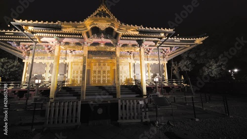 tokyo, japan - november 05 2020: Pan video wide view of the golden Ueno Tosho-gu shrine dedicated to the Shogun Tokugawa Ieyasu and classed as Important cultural property at night. photo