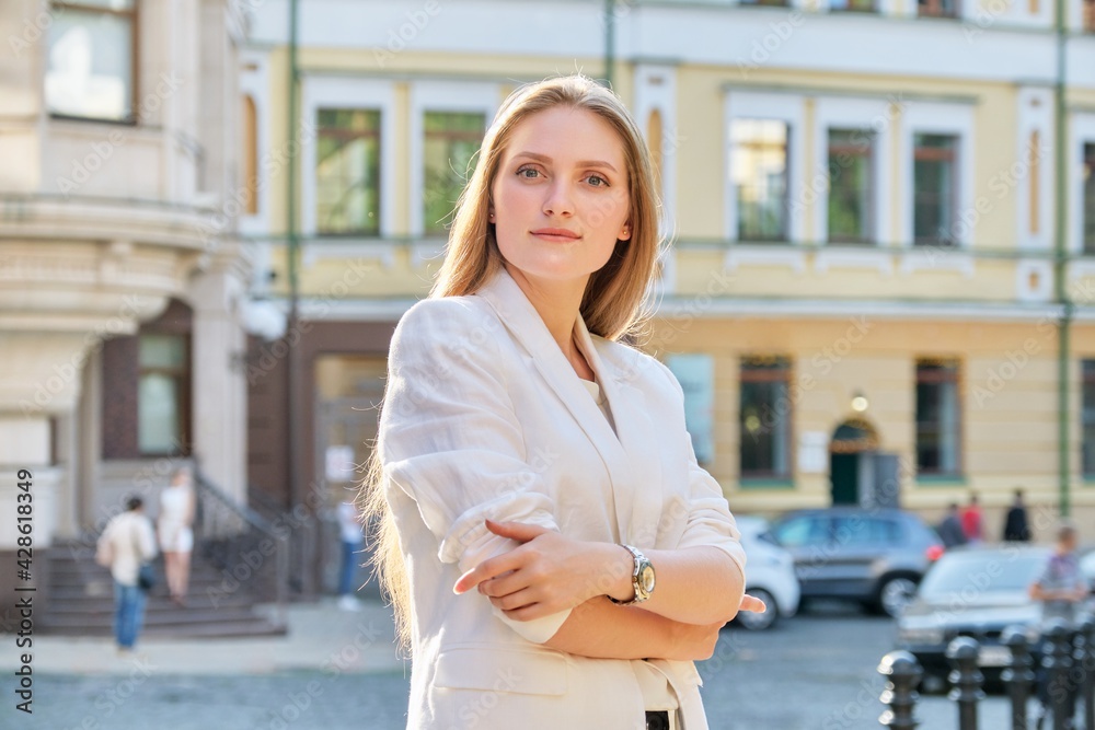 Outdoor portrait of young confident business woman with crossed arms Outdoor portrait of young confident business woman with crossed arms