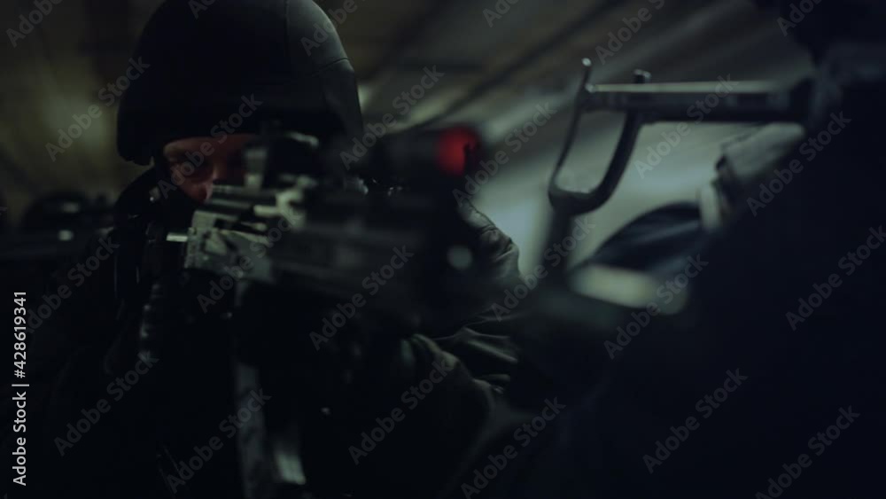 Front view SWAT officers with assault rifles moving towards camera Front view SWAT officers with assault rifles moving towards camera