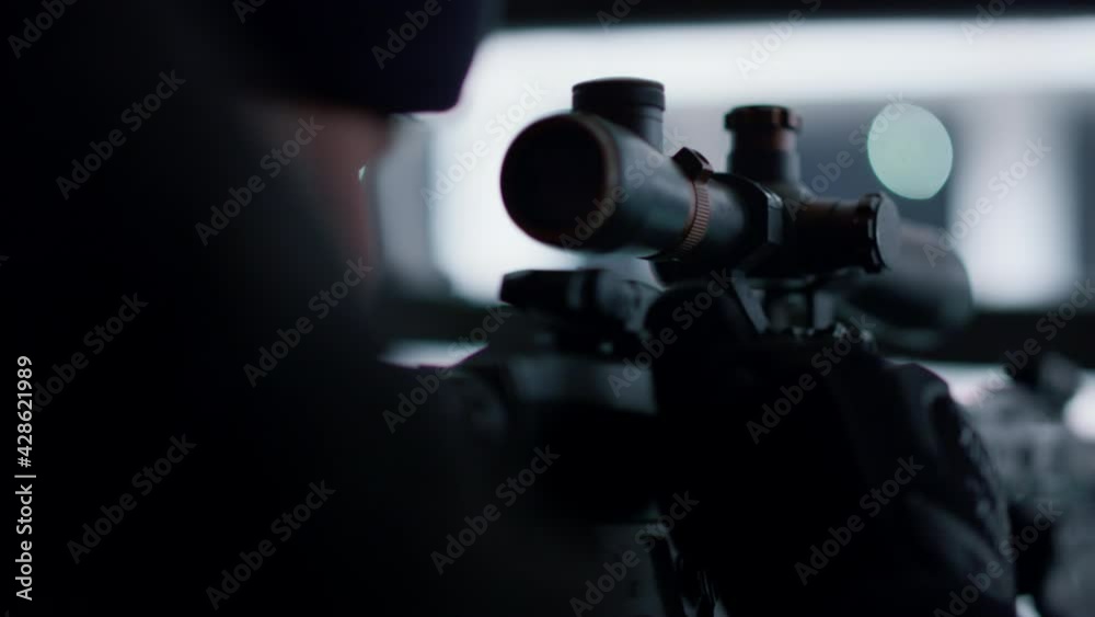 Sniper preparing to shoot with automatic rifle. Male soldier loading army weapon Sniper preparing to shoot with automatic rifle. Male soldier loading army weapon