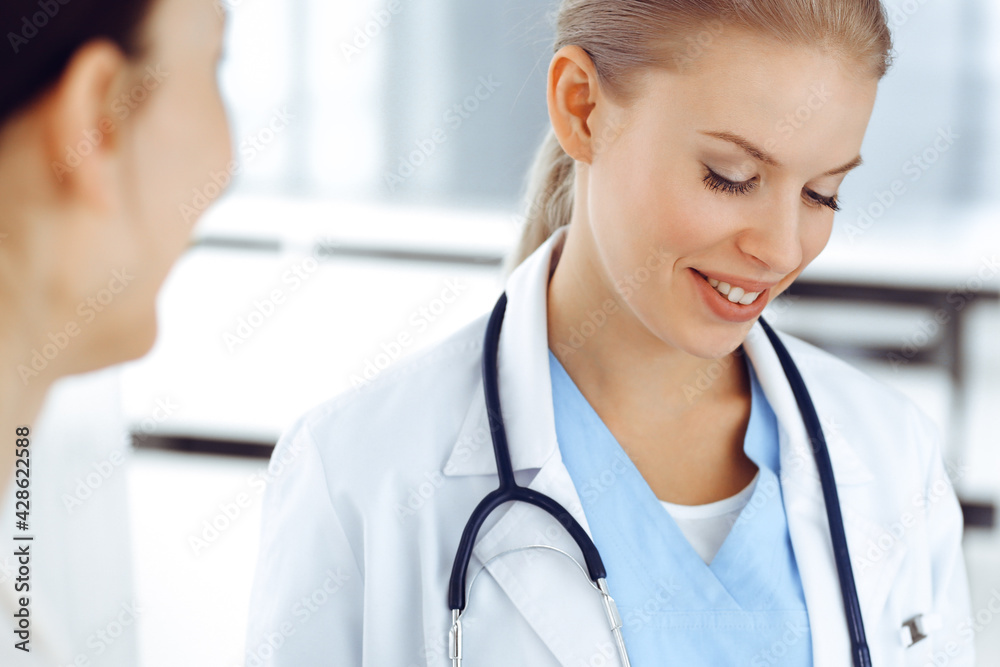 Woman - doctor consults her female patient while using clipboard and medication history record. Medicine concept Woman - doctor consults her female patient while using clipboard and medication history record. Medicine concept