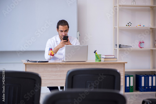 Young male doctor giving seminar in the classroom