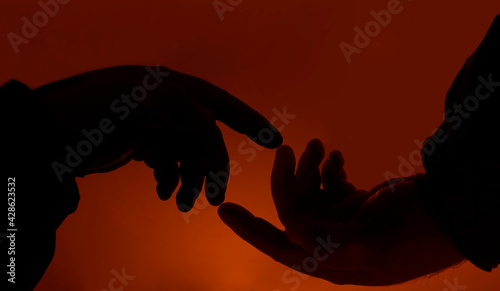 2 two men hands symbolizing union over the yellow or red  sky background. photo