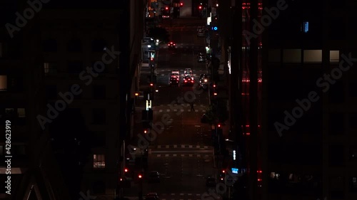 cars driving on dark city streets photo