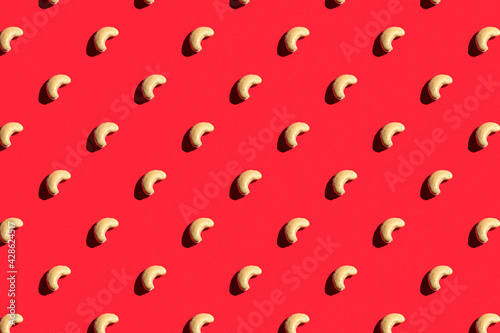 Pattern of cashew. Fashionable sunny porridge pattern on a bright red background. Colorful pattern. View from above