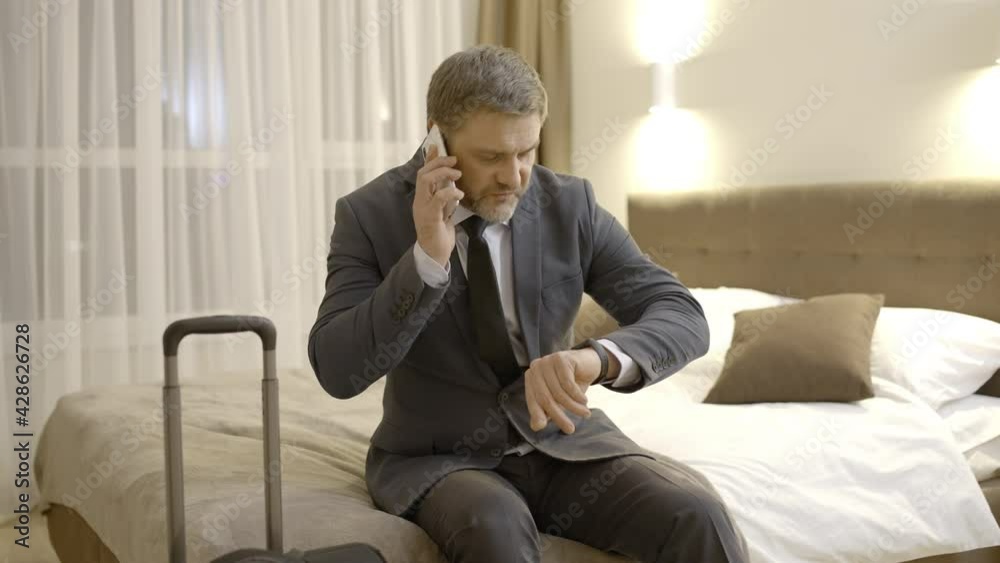 Annoyed male manager talking to taxi driver on phone, complaining about service