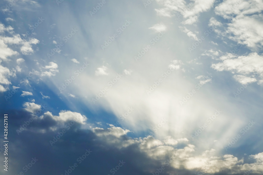 Blue sky with clouds and sunbeams Blue sky with clouds and sunbeams