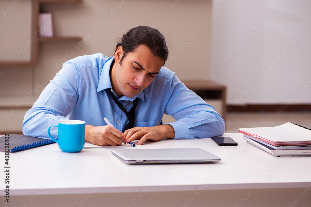 Young male employee working from home during pandemic Young male employee working from home during pandemic